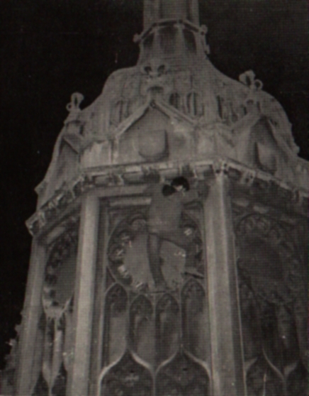 The climber has reached the base of the climb by a drainpipe from the ground. A variety of small holds give access to the clockface. It is essential to climb the clockface up the right-hand side.