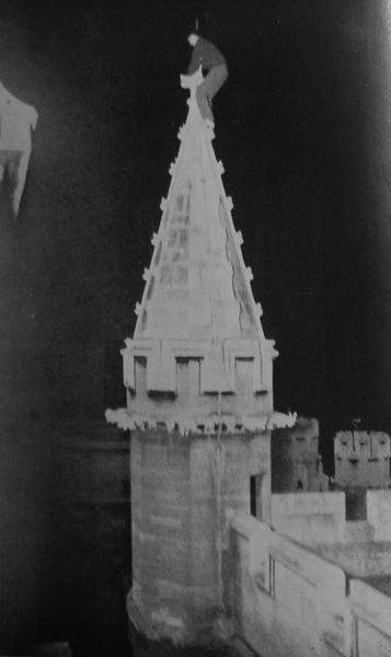 The O'Hara Pinnacle or Tottering Tower. At the moment of taking the photograph the top cross, which the climber is holding, was swaying. Note King's Chapel in the background.